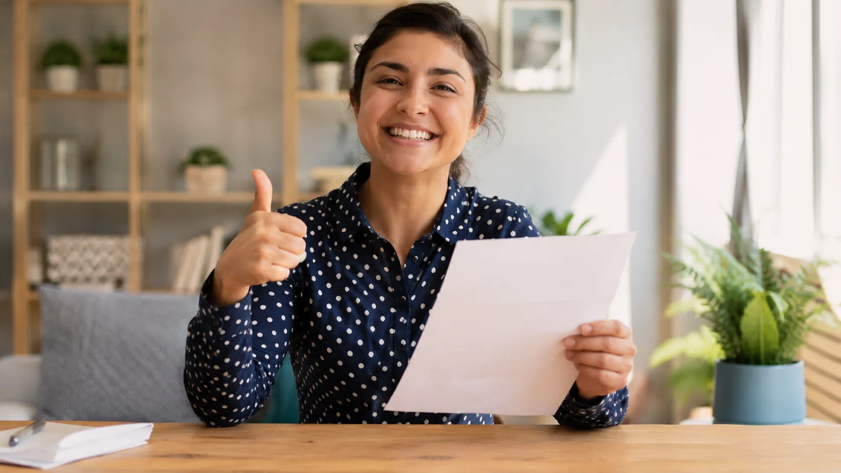 A confident person giving a thumbs-up after passing