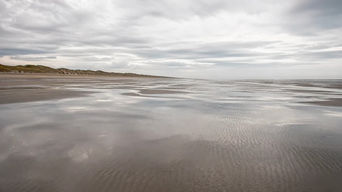 The sand and dunes of Juno Beach, near Courseulles-sur-Mer in Normandy, under a grey sky